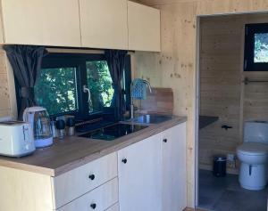 a kitchen with a sink and a toilet in a room at Roque Rouge Cottage by Tiny Away in Bédarieux