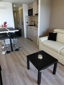 a living room with a couch and a table at Appartement en bord de mer in Cannes