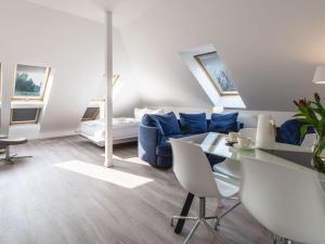 a living room with a blue couch and a table at Water Comfortable holiday residence in Ostseebad Koserow