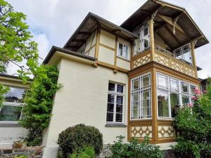a yellow and white house with windows at Salon Comfortable holiday residence in Heringsdorf