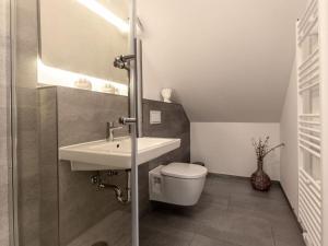 a bathroom with a sink and a toilet at Water Comfortable holiday residence in Ostseebad Koserow +16 photos