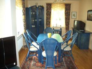 a dining room with a blue table and chairs at Picobello 2 Comfortable holiday residence in Timmendorfer Strand