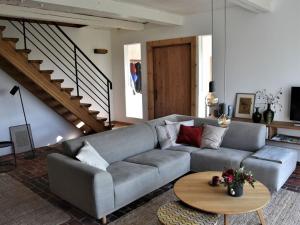 a living room with a couch and a table at Huus Uelvesbüll South-West in Uelvesbüll