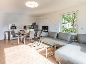 a living room with a couch and a table at Air Comfortable holiday residence in Ostseebad Koserow