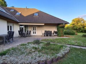 a house with a patio with tables and chairs at Air Comfortable holiday residence in Ostseebad Koserow