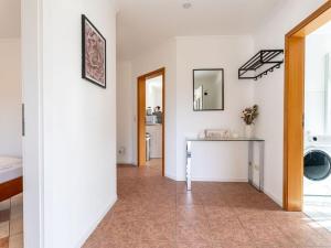 a hallway with white walls and a table in a room at Air Comfortable holiday residence in Ostseebad Koserow +16 photos