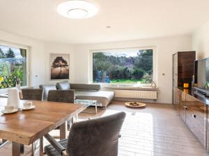 a living room with a table and a couch at Air Comfortable holiday residence in Ostseebad Koserow
