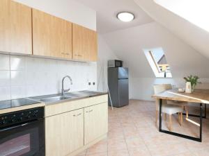 a kitchen with a sink and a refrigerator at Space Comfortable holiday residence in Ostseebad Koserow