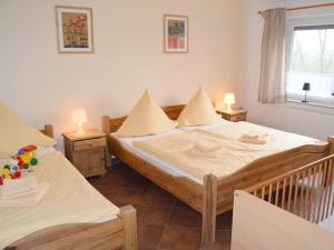 a bedroom with two beds and a window at Windrose Comfortable holiday residence in Norddeich