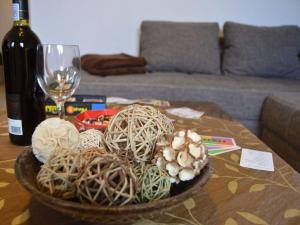 a bowl of balls on a table with a wine glass at Deichstübchen Comfortable holiday residence in Norddeich