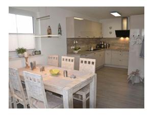 a kitchen with a wooden table and chairs in a room at Starfish Comfortable holiday residence in Breege