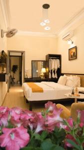 a hotel room with a bed and flowers in the foreground at Hanoi Family Homestay in Hanoi