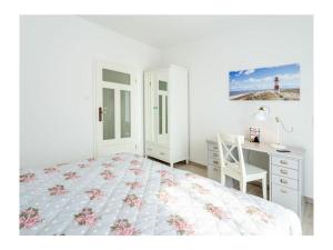 a bedroom with a bed and a desk and a lighthouse at Three-master house no 1 in Breege