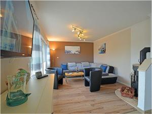 a living room with a couch and a table at Penthouse Sea Breeze in Juliusruh