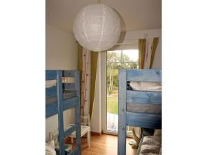 a room with two bunk beds and a lamp at At the Dune Comfortable holiday residence in Juliusruh