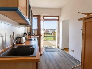 a kitchen with a sink and a counter top at Spring Comfortable holiday residence in Ostseebad Karlshagen