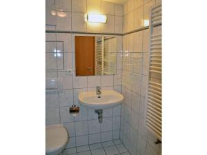 a white bathroom with a sink and a mirror at Arkonablick No 66 Comfortable holiday residence in Juliusruh