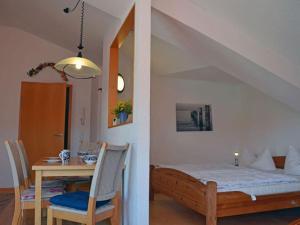 a bedroom with a bed and a dining room table at Arkonablick No 66 Comfortable holiday residence in Juliusruh +7 photos