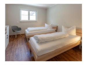 two beds in a room with a window at Three-master house no 2 in Breege