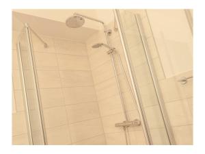 a shower with a glass door in a bathroom at Three-master house no 2 in Breege +12 photos