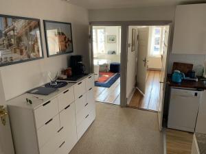 a kitchen with white cabinets and a door to a room at On the Trave Comfortable holiday residence in Travemünde