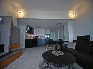 a living room with a couch and a table at Villa Düne "Penthouse Apartment" in Baabe