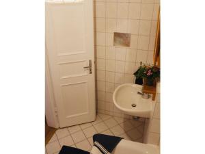 a white bathroom with a sink and a toilet at Roßplatz in the center in Leipzig