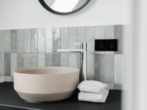 a bath tub in a bathroom with a mirror at Mooi 2 Comfortable holiday residence in Norderney