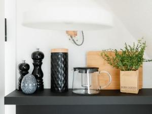 uma prateleira preta com vasos e um liquidificador em Mooi 2 Comfortable holiday residence em Norderney