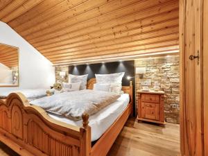 a bedroom with a large bed with a wooden ceiling at Kirchberger Comfortable holiday residence in Bodenmais