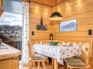 a dining room with a table and chairs and a window at Kirchberger Comfortable holiday residence in Bodenmais