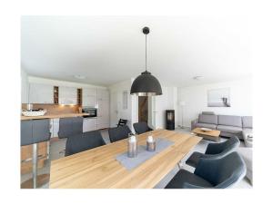 a dining room and living room with a table and chairs at Meerzeit Comfortable holiday residence in Juliusruh
