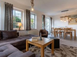 a living room with a couch and a table at Luxury house R1 Comfortable holiday residence in Sankt Peter-Ording