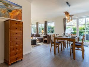 a dining room and living room with a table and chairs at Luxury house R1 Comfortable holiday residence in Sankt Peter-Ording +15 photos