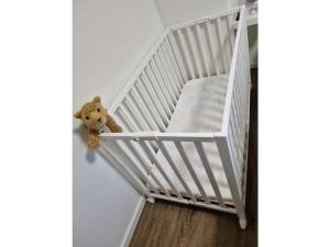 a teddy bear is hanging on a stair case at Anchorage Comfortable holiday residence in Fedderwardersiel