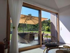 a room with a large window with a table and an umbrella at Jordans Kate Comfortable holiday residence in Xanten