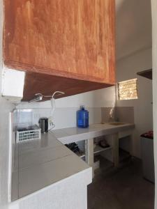 a kitchen with a counter top and a wooden cabinet at Sea Esta Beach House in Boljoon