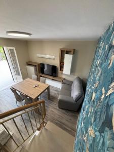 a living room with a couch and a table at Villetta a 200 m dalla riva in Lido di Classe