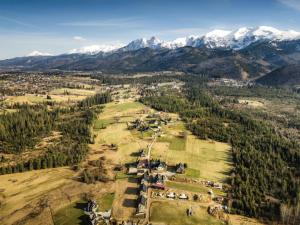 an aerial view of a farm with mountains in the background at Villa Alexandra in Kościelisko