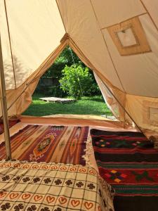 a tent with a bed and rug in a room at Camping Kromidovo in Kromidovo
