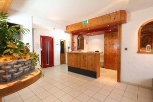 a large room with a kitchen with a counter at Hotel Alpina Dependance vom Hotel Desiree in Grächen