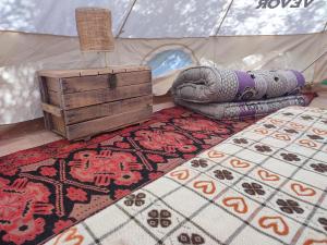 a room with a tent with a rug and a rug at Camping Kromidovo in Kromidovo
