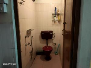 a small bathroom with a toilet and a shower at Imperial Heritage Home in Port Blair