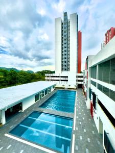 a swimming pool on the roof of a building at A Room - Stay With the Host in Ipoh