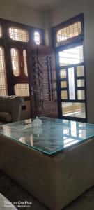 a glass counter in a room with windows at Indipendent Home Stay at Jankupuram Lucknow in Lucknow
