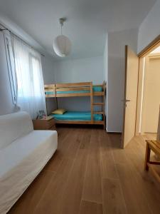 a bedroom with a bed and bunk beds in it at PLATANES PLACE in Platanes