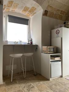 une cuisine avec un comptoir, une table et une fenêtre dans l'établissement Aqua - Letto e Colazione, à Acquaviva delle Fonti