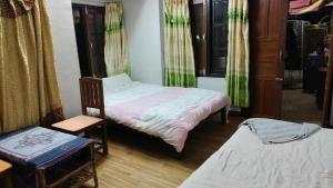 um quarto com uma cama e uma cadeira e uma cadeira em Monkey Temple Homestay em Kathmandu