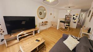 a living room with a large flat screen tv at Maison rénovée, Agen centre in Agen