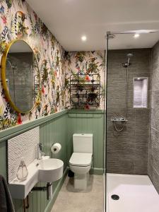 a bathroom with a toilet and a sink and a shower at Luxury townhouse - your perfect retreat in Hertford in Hertford